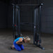 Body-Solid Powerline PFT100 Functional Trainer - woman crouching