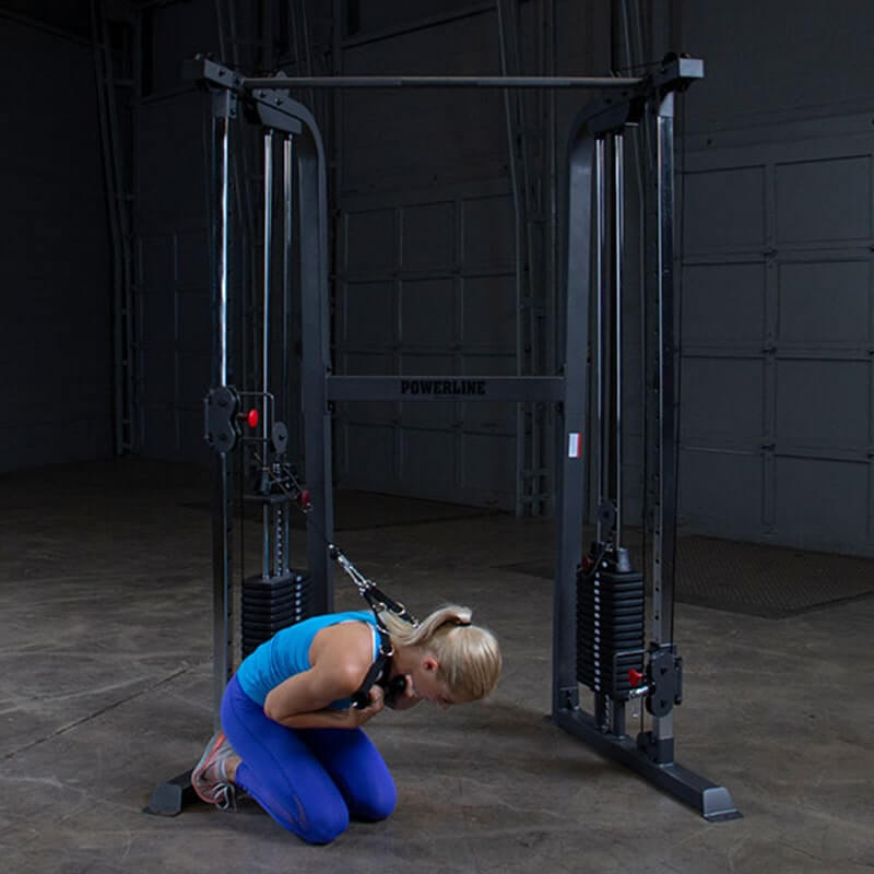 Body-Solid Powerline PFT100 Functional Trainer - woman crouching