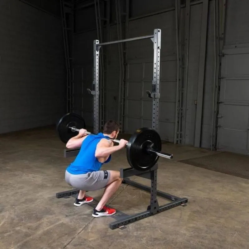 Body-Solid Powerline Half Rack PPR500 - man doing bench press next to a metal bar