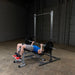 Body-Solid Powerline Half Rack PPR500 - man doing bench press next to it 