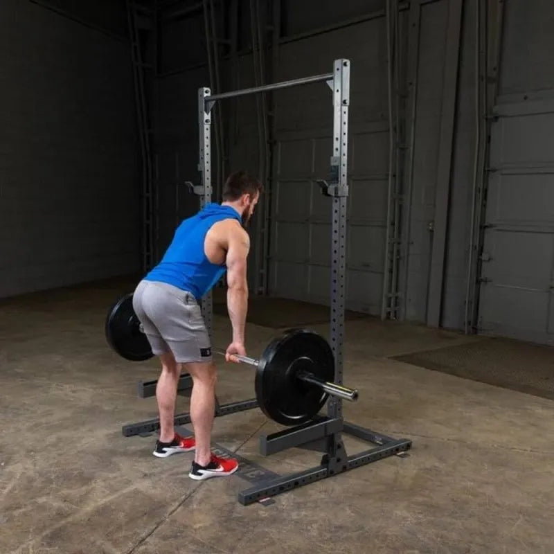 Body-Solid Powerline Half Rack PPR500 - man lifting weights beside the metal bar