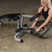 Body-Solid Powerline Leg Extension & Curl Machine PLCE165X - woman adjusting the machine