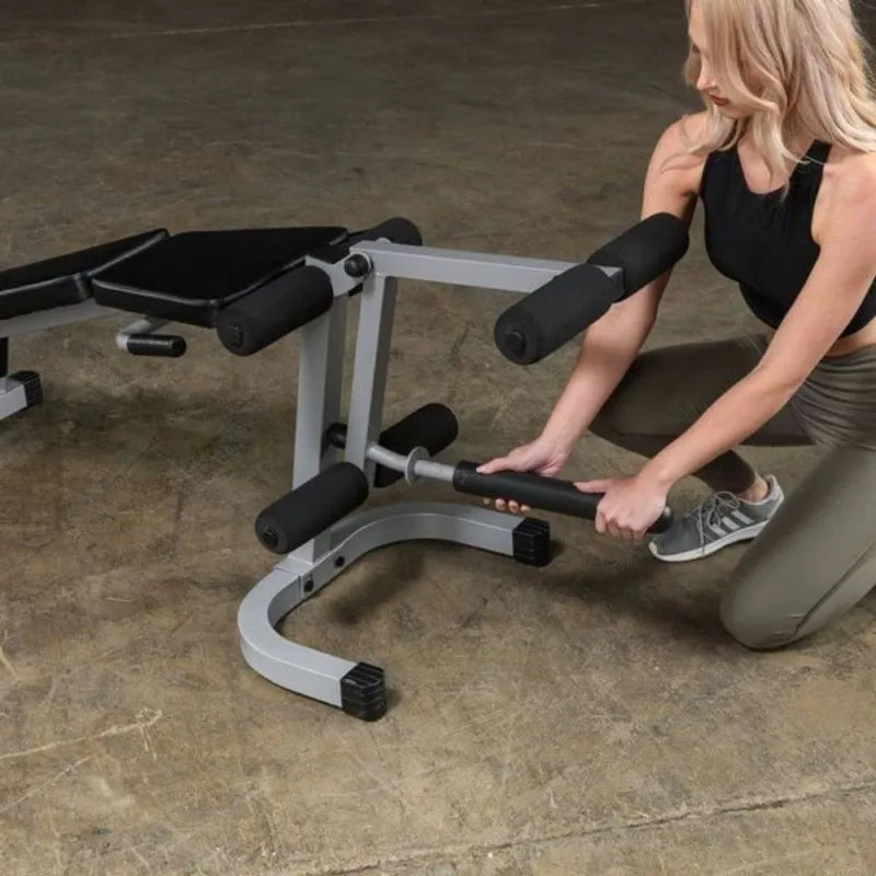 Body-Solid Powerline Leg Extension & Curl Machine PLCE165X - woman adjusting the machine