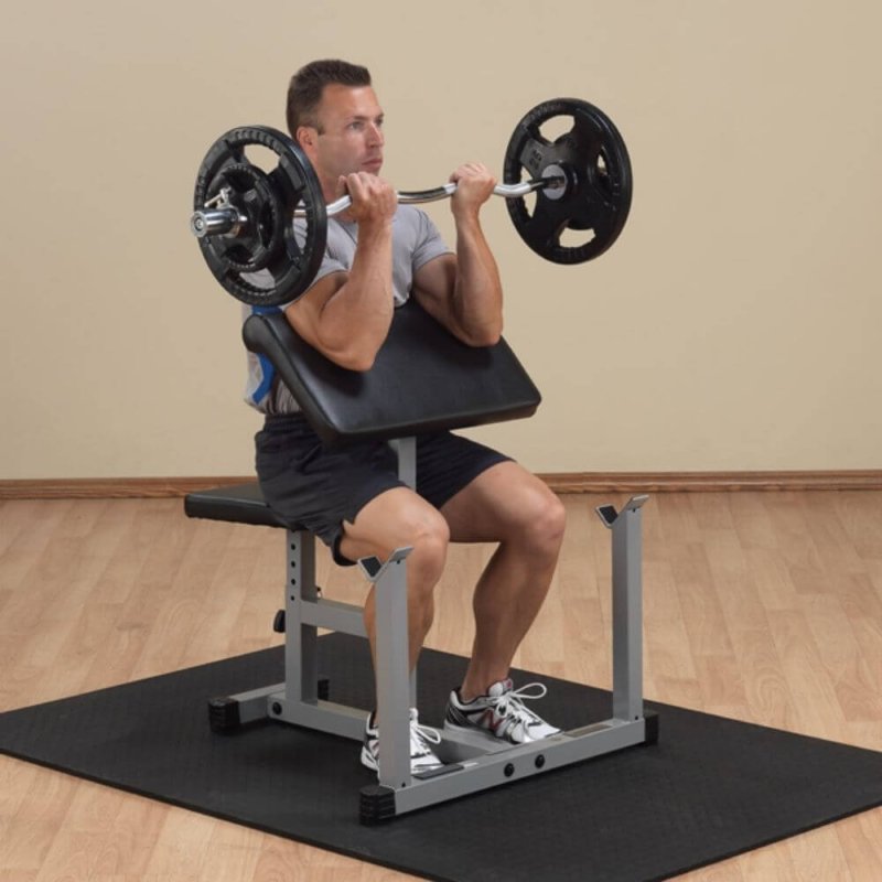 Body-Solid Powerline Preacher Curl Bench PPB32X - man exercising