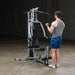 Body-Solid Powerline Single Stack Home Gym BSG10X - man standing next to a gym equipment