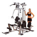 Body-Solid Powerline Single Stack Home Gym P2X - woman standing next to it