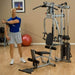 Body-Solid Powerline Single Stack Home Gym P2X - next to sets of dumbells