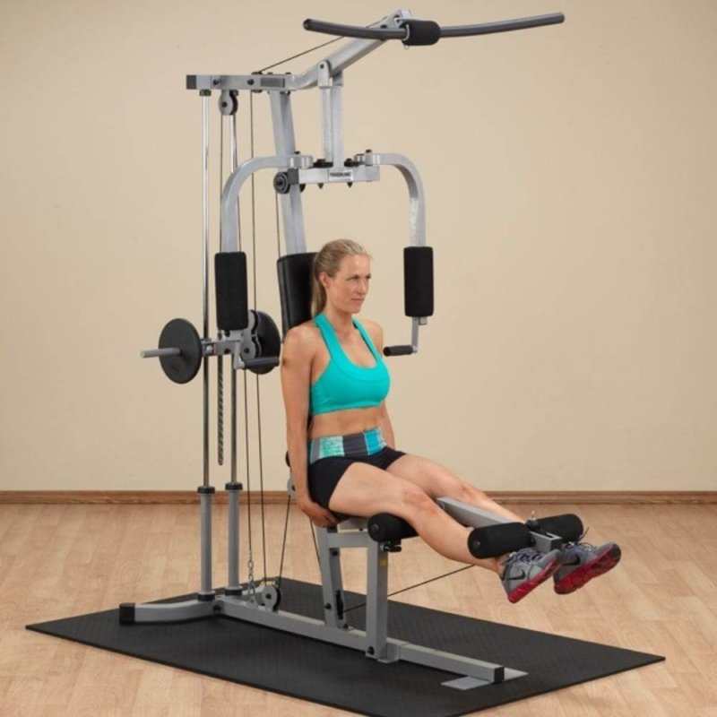 Body-Solid Powerline Single Stack Home Gym PHG1000X - woman sitting on bench 