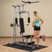 Body-Solid Powerline Single Stack Home Gym PHG1000X - woman doing leg exercise