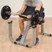 Body-Solid Preacher Curl Bench GPCB329 - Actual photo of man sitting and using the body support to work out muscles