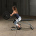 Body-Solid Preacher Curl Station GPCA1 - side view photo of a woman using the product