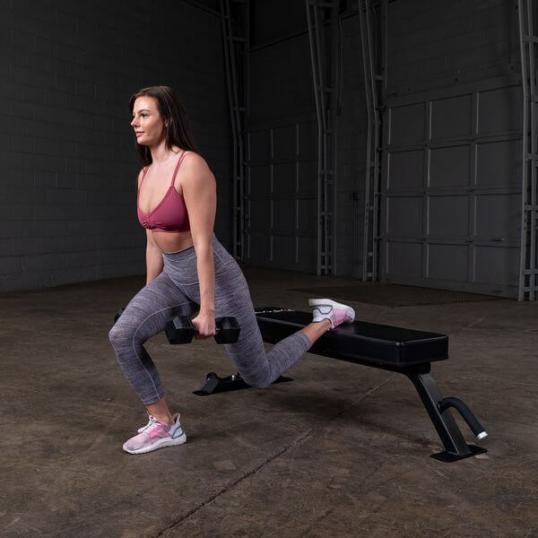 Body Solid Pro Club Line Flat Utility Bench - woman doing exercises