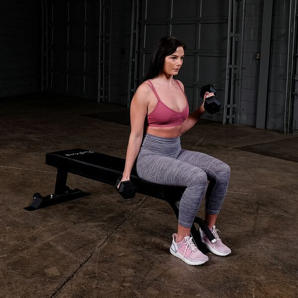 Body Solid Pro Club Line Flat Utility Bench - woman sitting down