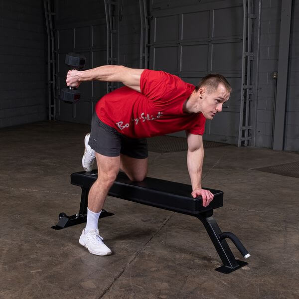 Body Solid Pro Club Line Flat Utility Bench - man using it 