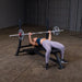 Body Solid Pro Club Line Oly Flat Bench - woman lifting barbel 