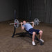 Body Solid Pro Club Line Oly Incline Bench - man doing weights 