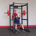 Body Solid Pro Club Line Power Rack Base Rack SPR1000 and Extension - men lifting barbels 