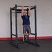 Body Solid Pro Club Line Power Rack Double Rack/Extension w Monkey Bar - man doing pull ups