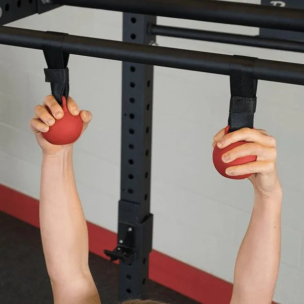 Body Solid Pro Club Line Power Rack Double Rack/Extension w Monkey Bar - hand holding 2 red balls 