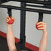 Body Solid Pro Club Line Power Rack Double Rack/Extension w Monkey Bar - hand holding 2 red balls 