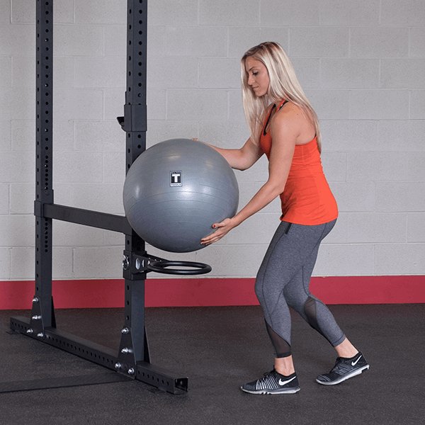 Body Solid Pro Club Line Power Rack Double SPR1000 w. Monkey Bar - man holding exercise ball