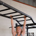 Body Solid Pro Club Line Power Rack Double SPR1000 w. Monkey Bar - woman on monkey bar 