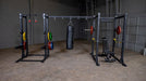 Body Solid Pro Club Line Power Rack, Half Rack Connecting Bar - different colored barbels on it 