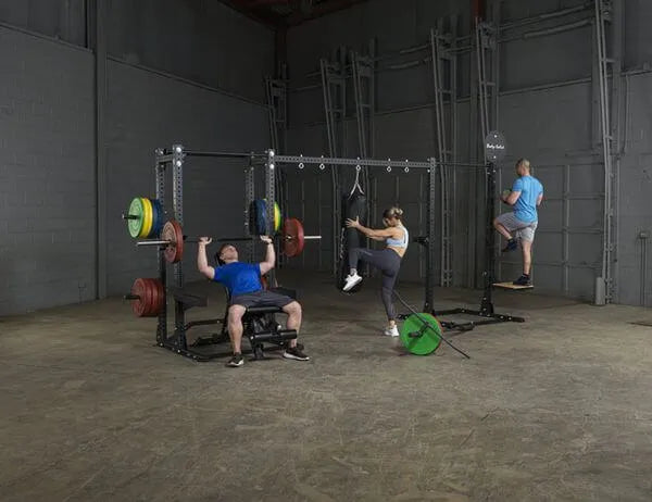 Body Solid Pro Club Line Power Rack, Half Rack Connecting Bar - group of people working out