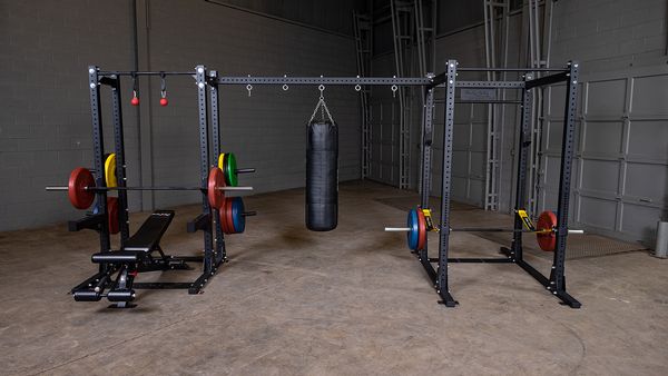 Body Solid Pro Club Line Power Rack, Half Rack Connecting Bar - punching bag hannging on it 