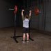 Body Solid Pro Club Line Squat Stand - man lifting weights