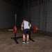 Body Solid Pro Club Line Squat Stand - man lifting red barbel