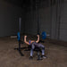 Body Solid Pro Club Line Squat Stand - woman lifting weights