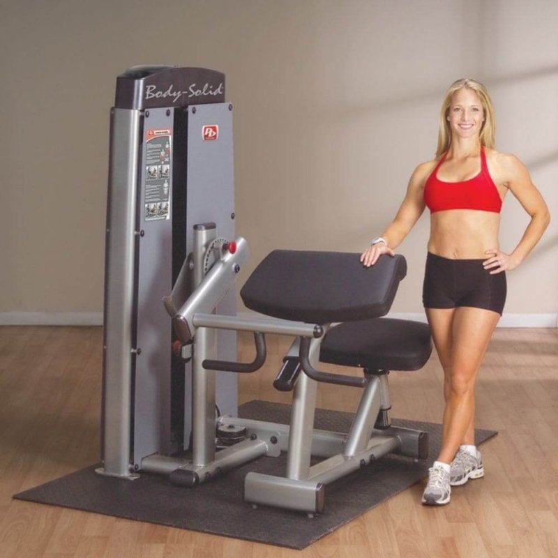 Body-Solid Pro Dual Commercial Bicep/Tricep Machine DBTC-SF - smiling woman while holding the machine