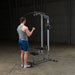 Body-Solid Pro Lat Pulldown Low Row Machine GLM83 - Man working on low pulleys