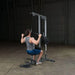 Body-Solid Pro Lat Pulldown Low Row Machine GLM83  - Man on a lat down exercise