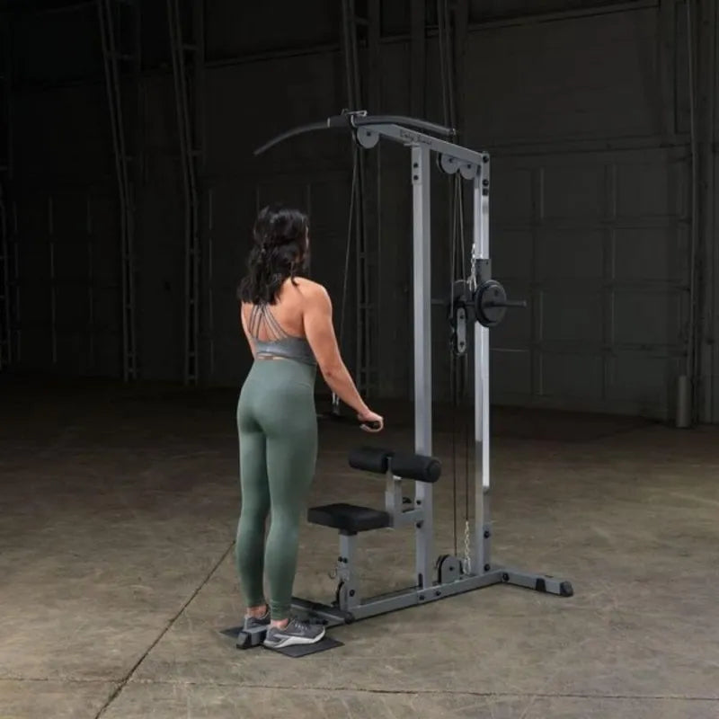 Body-Solid Pro Lat Pulldown Low Row Machine GLM83 - woman standing doing triceps pressdown