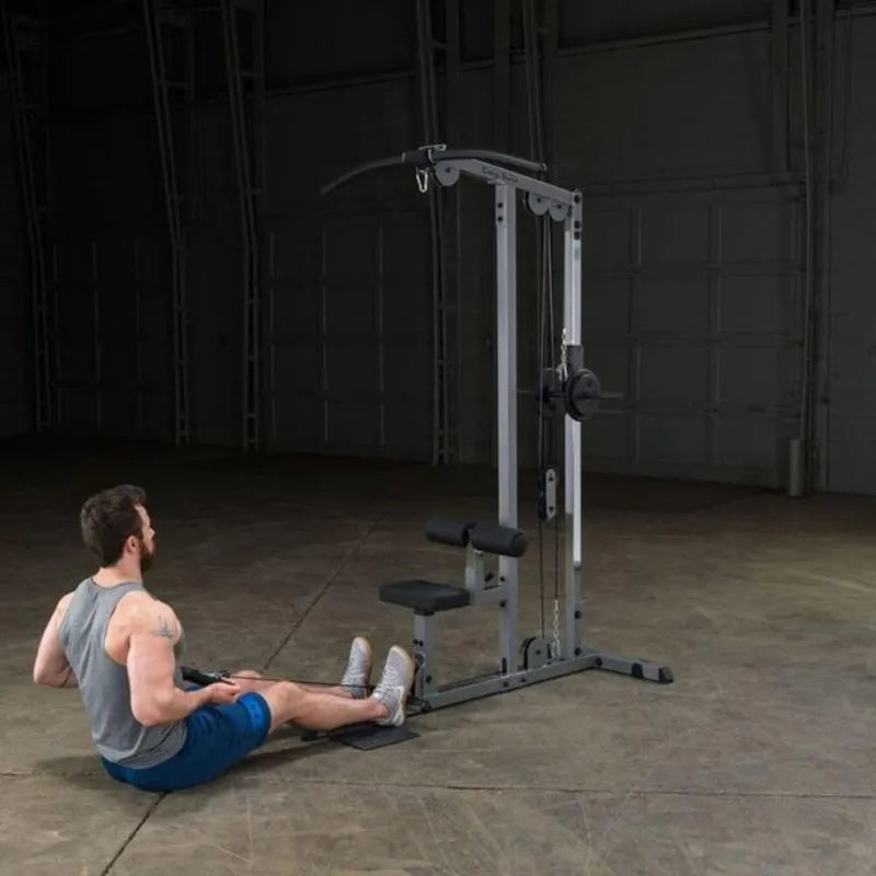 Body-Solid Pro Lat Pulldown Low Row Machine GLM83 - Man sitting on the ground doing seat row exercise