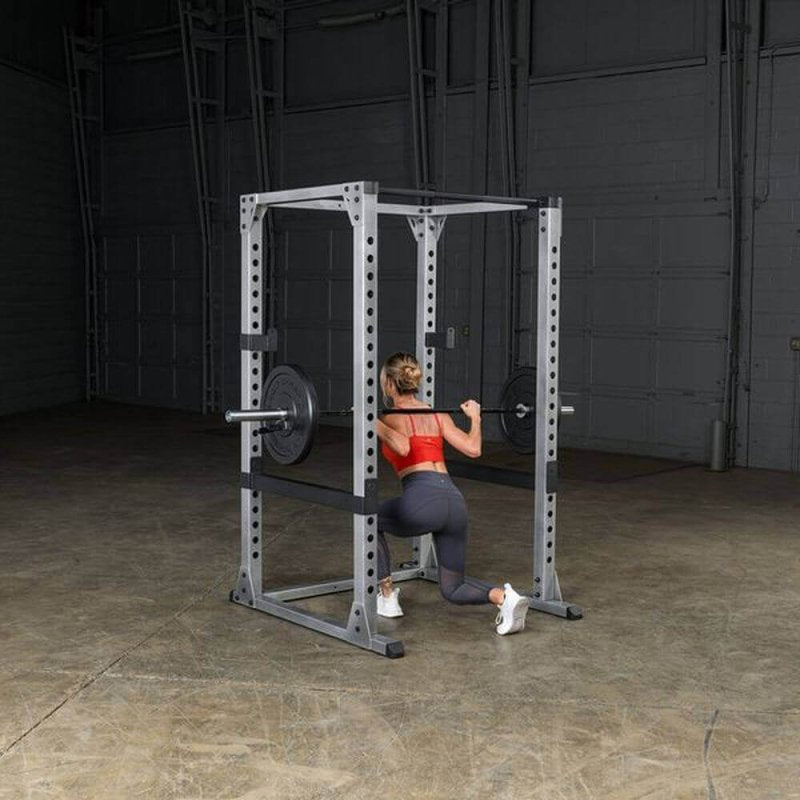 Body-Solid Pro Power Rack GPR378 - Woman kneeling down while barbell rod on her back