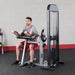 Body-Solid Pro Select Biceps And Triceps Machine GCBT-STK - Man sitting down while working out with arms