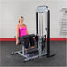 Body-Solid Pro Select Leg Extension Leg Curl Station GCEC-STK - woman working out using foot support