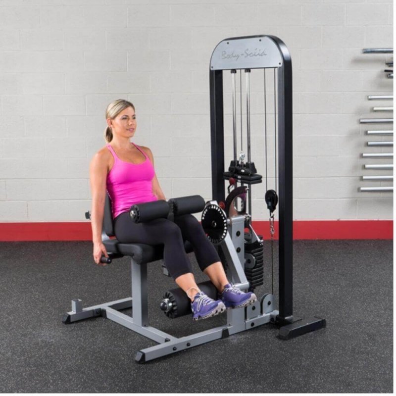 Body-Solid Pro Select Leg Extension Leg Curl Station GCEC-STK - woman resting rollers behind her legs