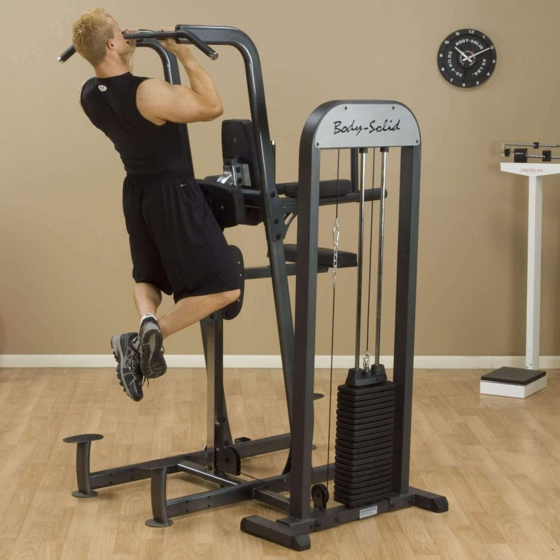 Body-Solid Pro Select Weight Assisted Chin-Dip Machine FCD-STK -  Man in chin up exercise with product