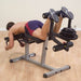 Body-Solid Seated Leg Extension & Supine Curl GLCE365 - Man inverted position using foot support for leg curl workout