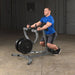 Body-Solid Seated Row Machine GSRM40 - Man sitting in seat cushioned while hands on handle bar