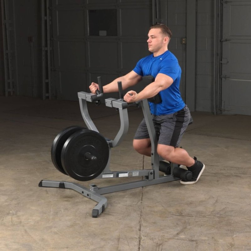 Body-Solid Seated Row Machine GSRM40 - Man sitting in seat cushioned while hands on handle bar