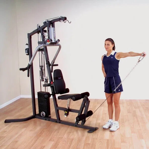Body-Solid Selectorized Single Stack Home Gym G3S - a woman standing next to a machine