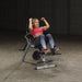 Body-Solid Semi-Recumbent Ab Bench GAB300 - Woman in pink top sitting on the bench working out