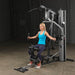 Body-Solid Single Stack Gym G5S - Female model on G1S holding arm handles