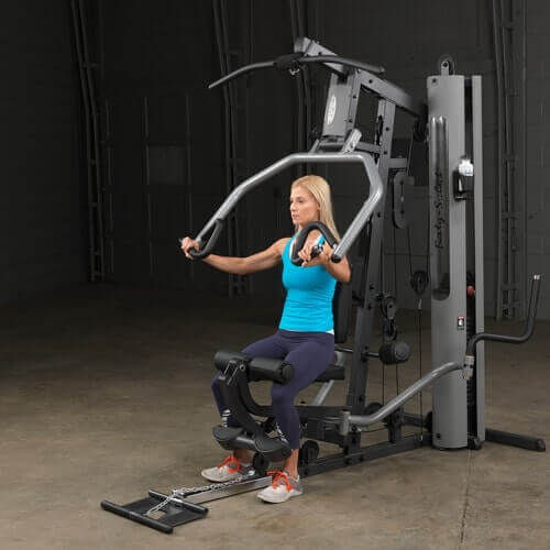 Body-Solid Single Stack Gym G5S - Woman in blue top sitting on bench pulling weights with both arms