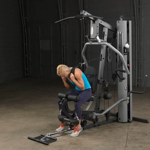 Body-Solid Single Stack Gym G5S - Woman sitting on bench while pulling weights from her back